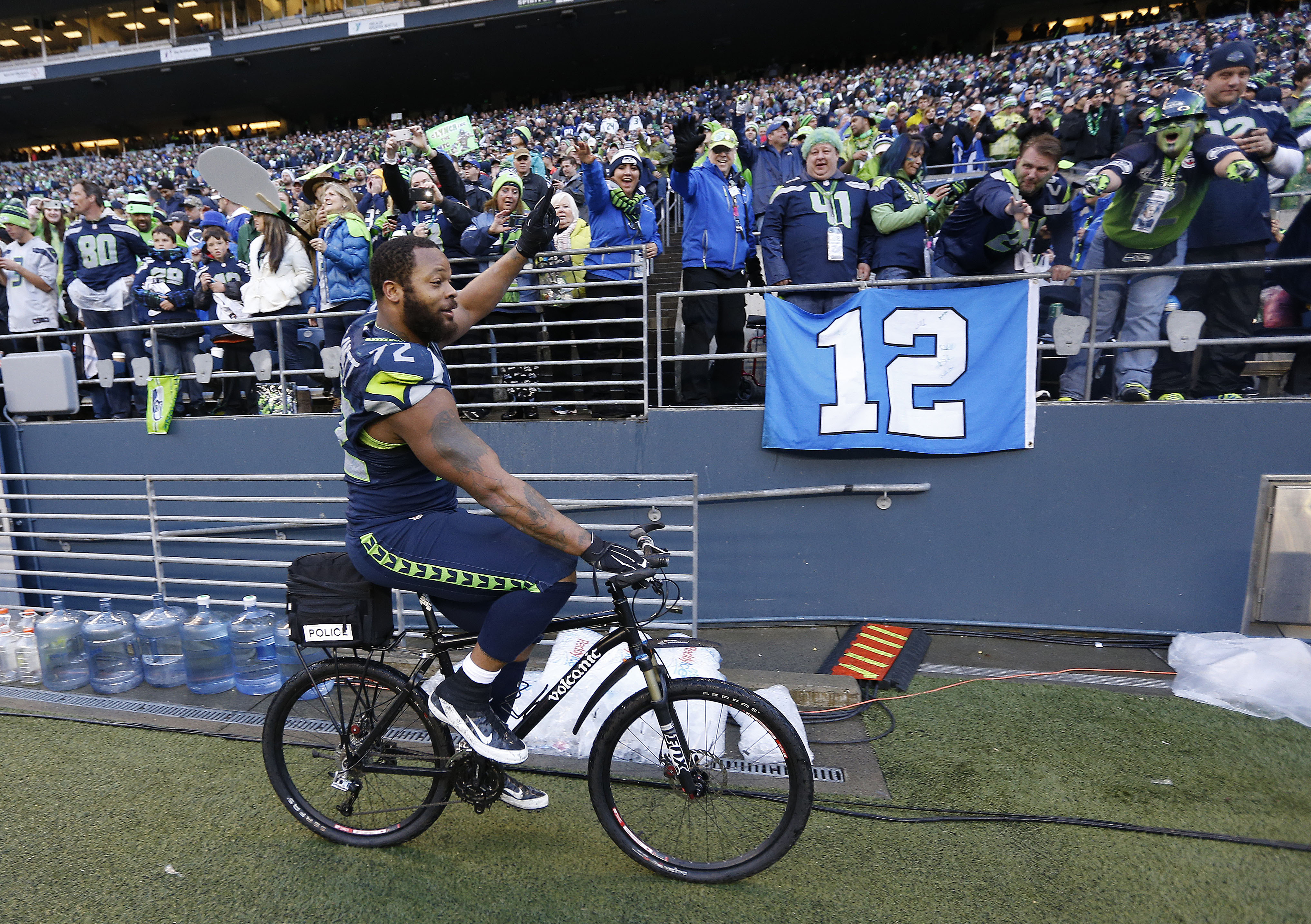 Seahawks DE Bennett celebrates with bicycle ride